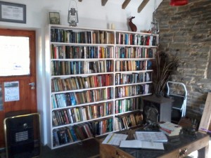 Bookcases full of books in a little cottage.